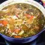 Homemade Chicken Broth in a blue pot.