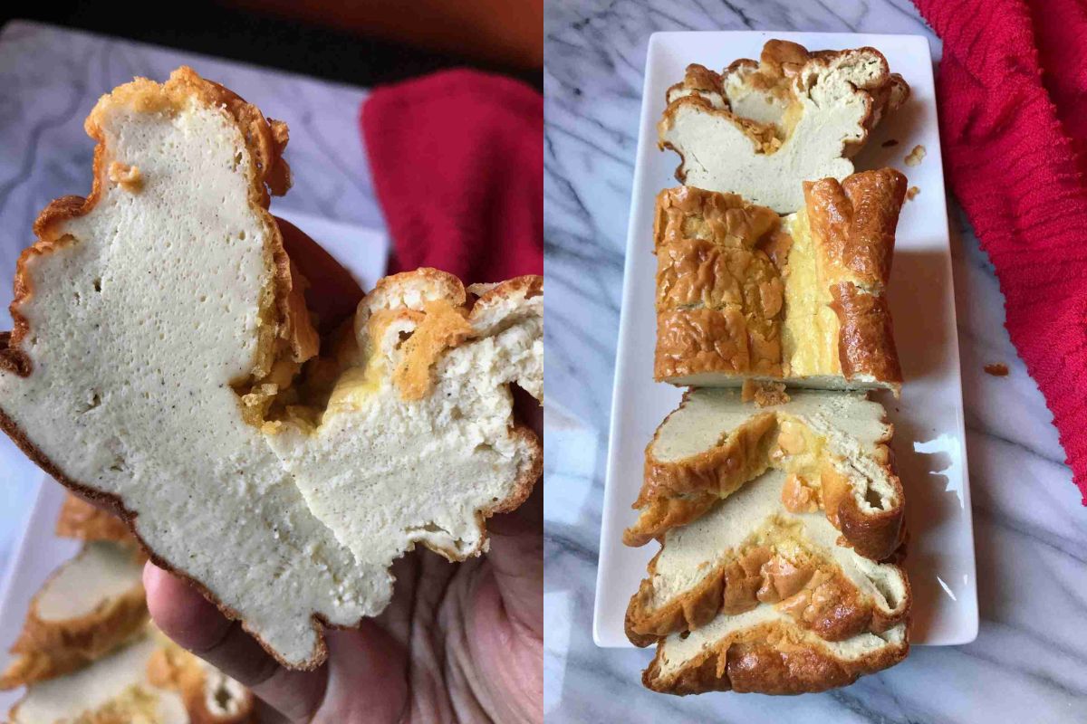 Sliced cloud bread on a marble surface, one piece held by hand. Red cloth nearby.