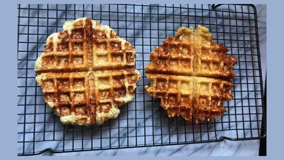 Two waffles on a cooling rack. The one on the left is lighter, while the one on the right is darker and more evenly cooked.